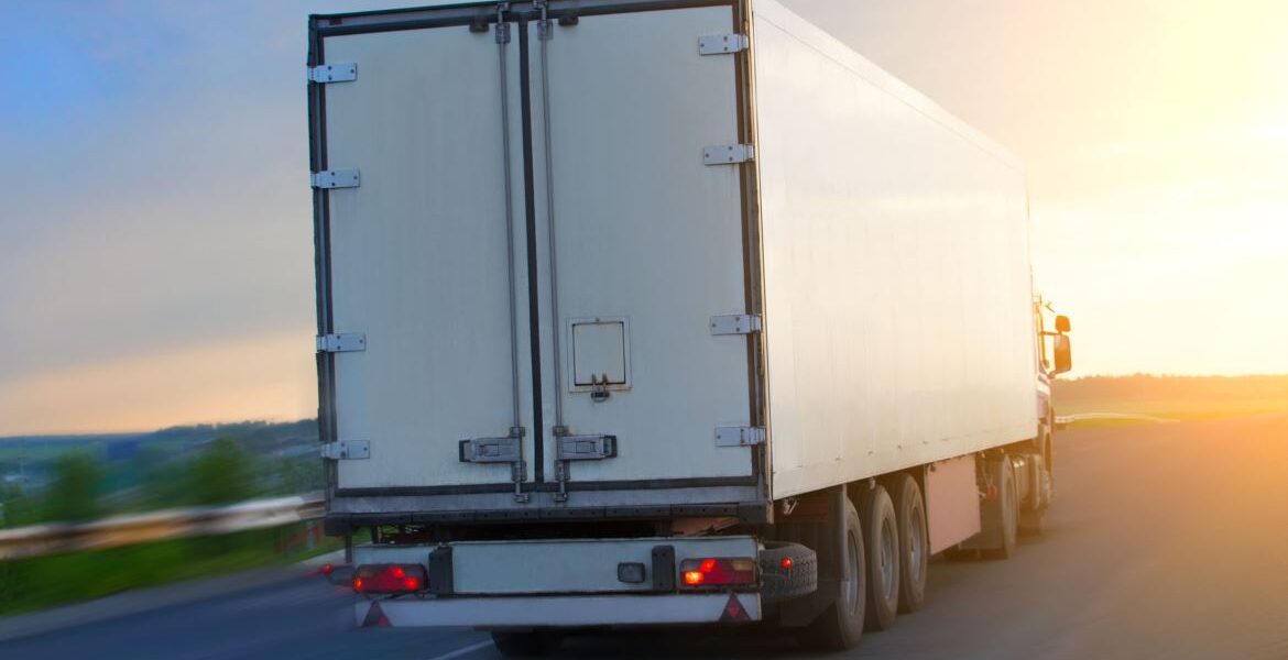 big truck moves on highway at sunrise