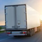 big truck moves on highway at sunrise