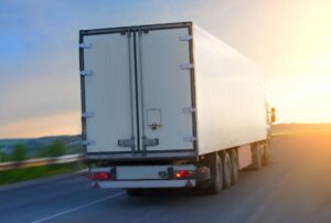 big truck moves on highway at sunrise